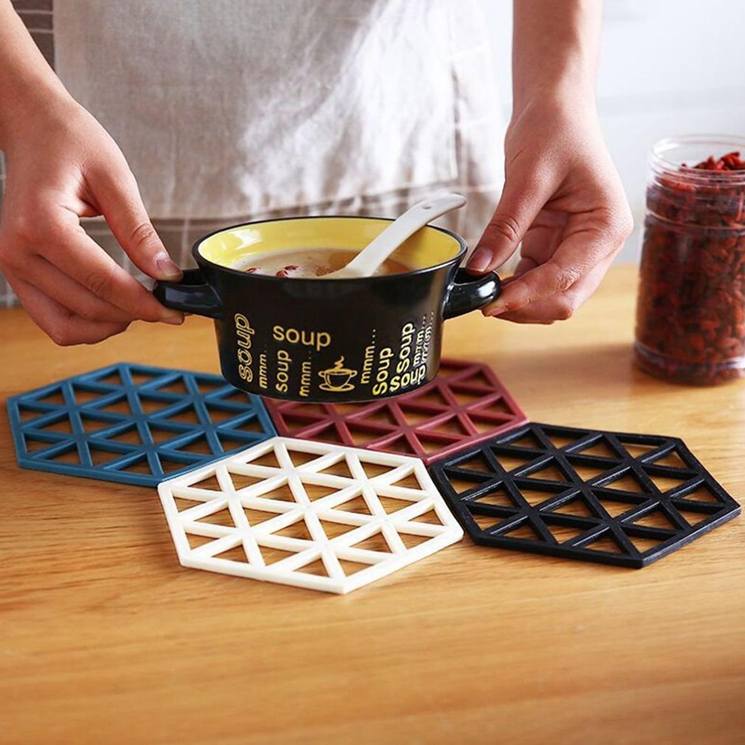 Multicolor PVC tea coasters used under a soup bowl, highlighting their non-slip and heat-resistant functionality for kitchen use.