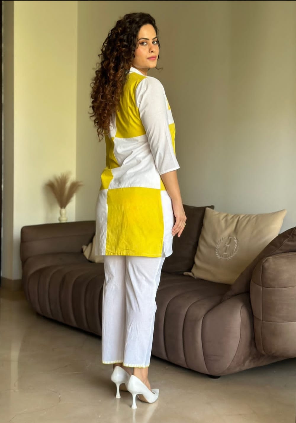 Back view of yellow cotton co-ord set with fancy buttons