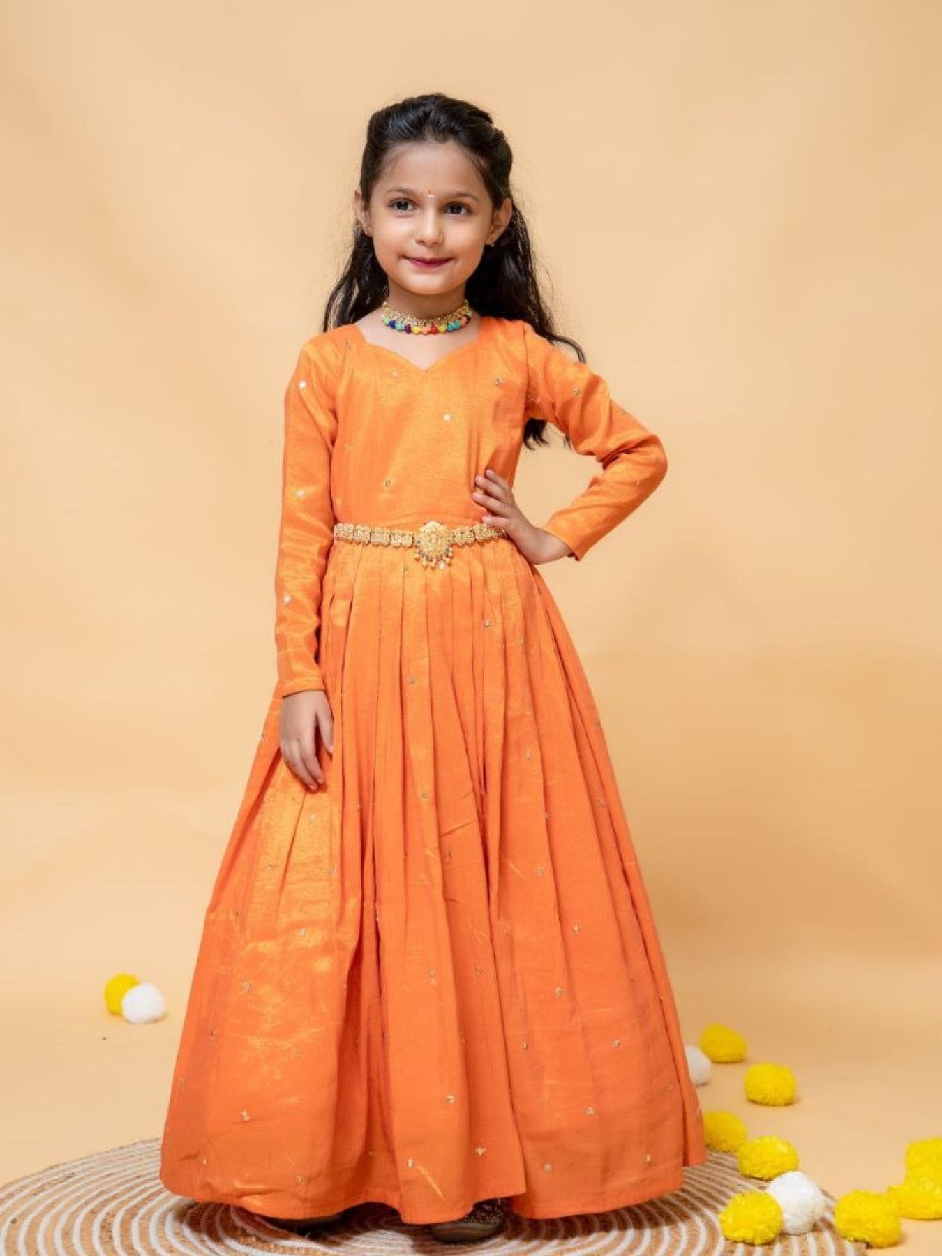 Girl in orange silk gown with dupatta, embroidery details