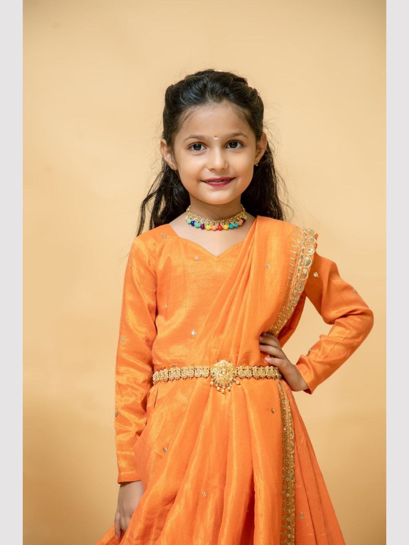 Close-up of girl in orange silk gown with dupatta