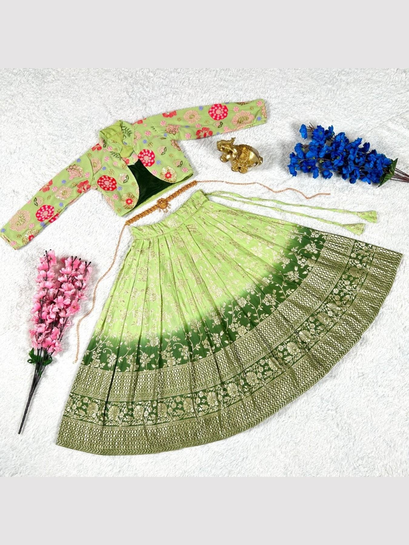 Green lehenga choli set with floral embroidery and accessories